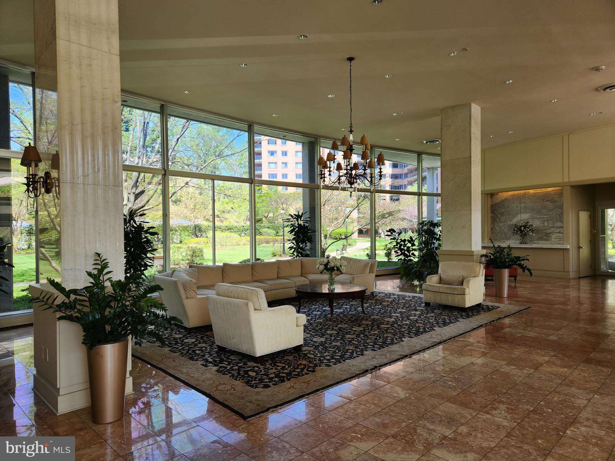 4201 Cathedral Avenue Northwest, Unit 1012E Washington, DC 20016 - Photo 9 of 18 a living room with furniture and a chandelier