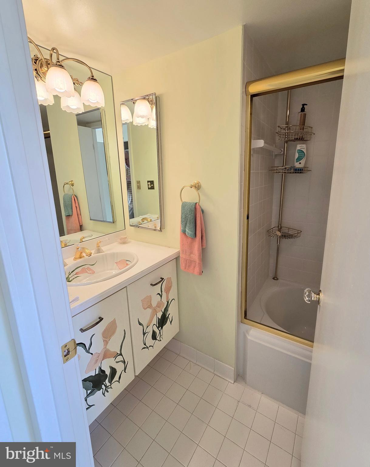 2111 Wisconsin Avenue Northwest, Unit 401 Washington, DC 20007 - Photo 12 of 16 a bathroom with a tub a sink and a mirror