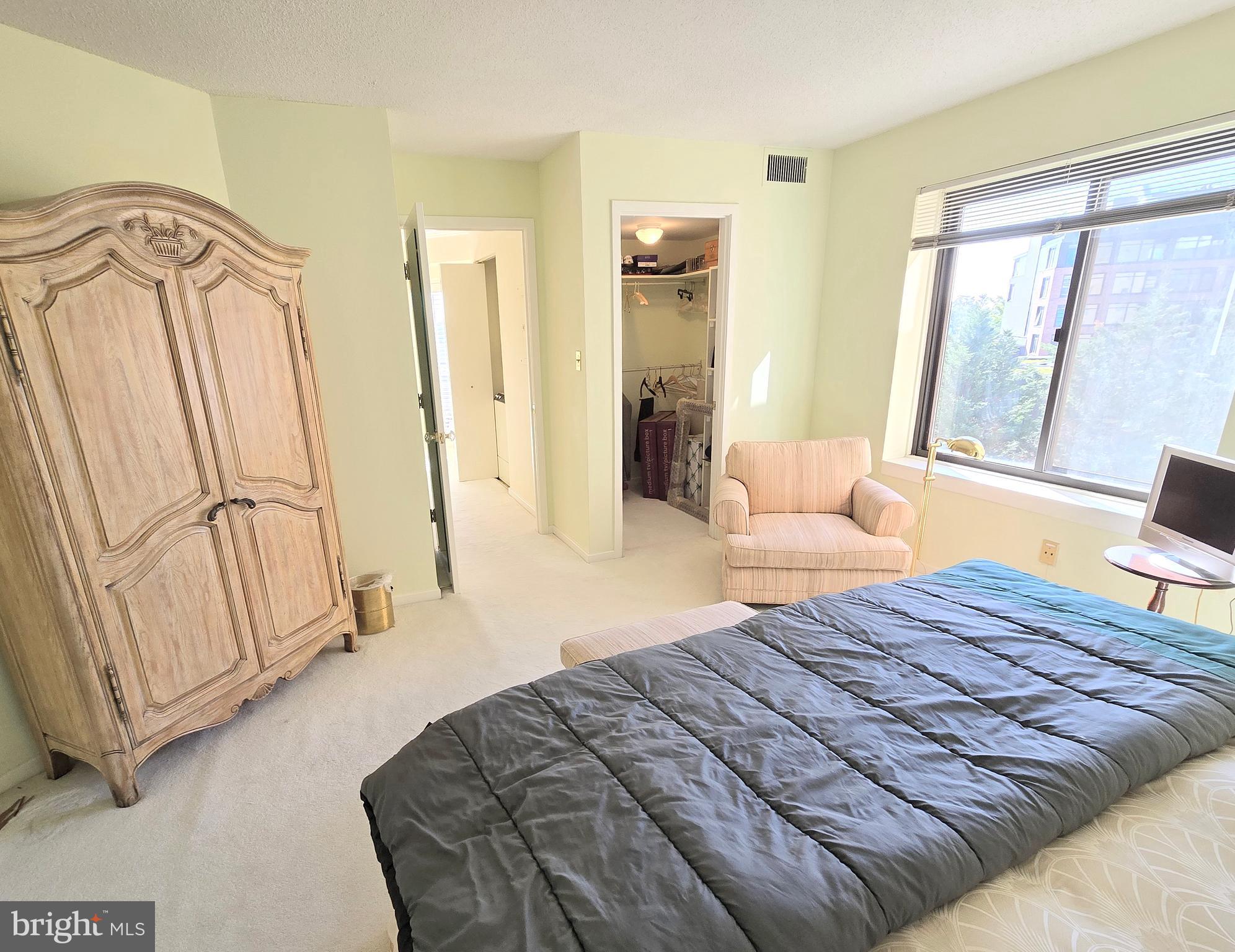 2111 Wisconsin Avenue Northwest, Unit 401 Washington, DC 20007 - Photo 15 of 16 a bedroom with a bed and a window