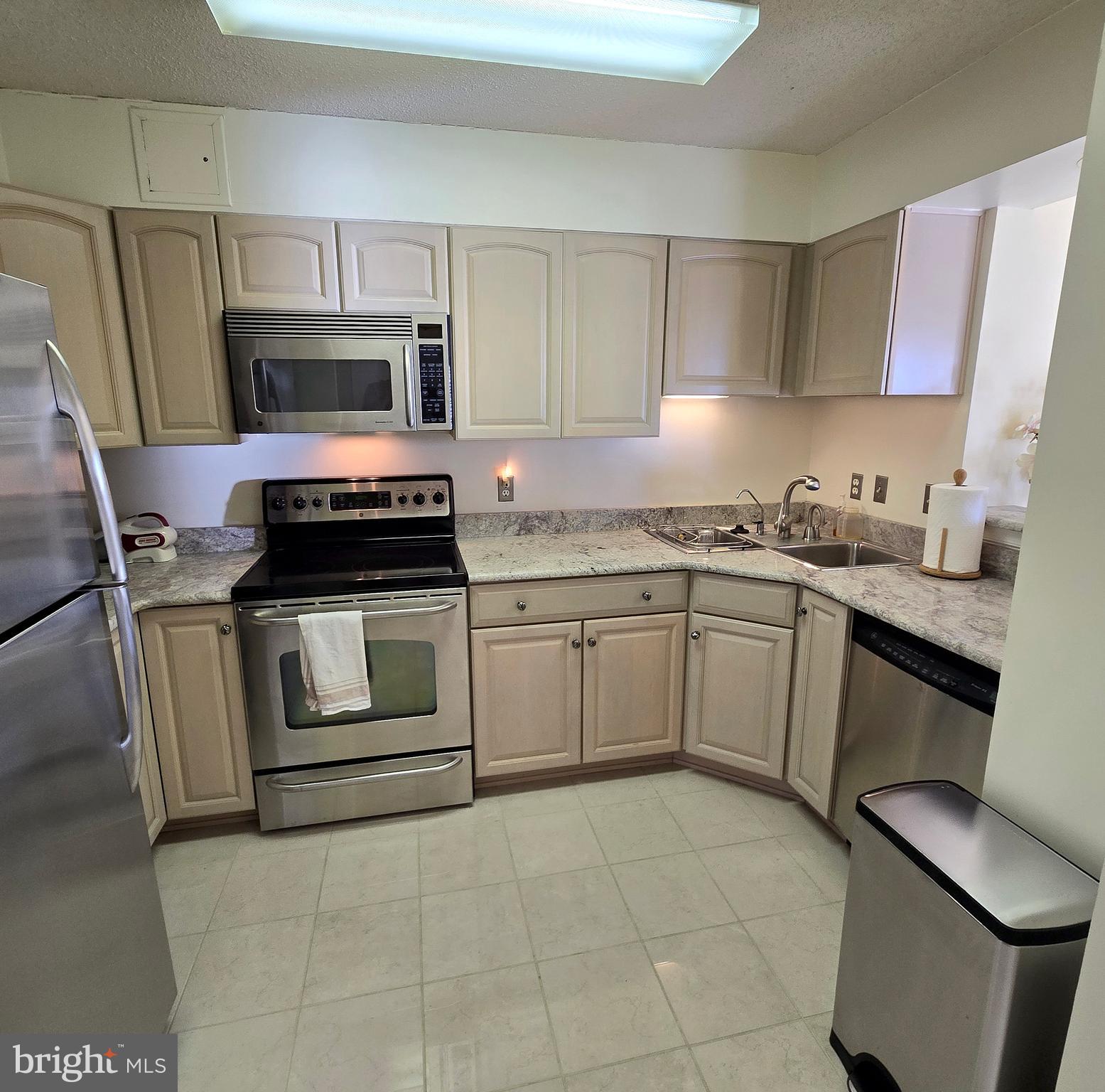 2111 Wisconsin Avenue Northwest, Unit 401 Washington, DC 20007 - Photo 3 of 16 a kitchen with a sink stove and microwave