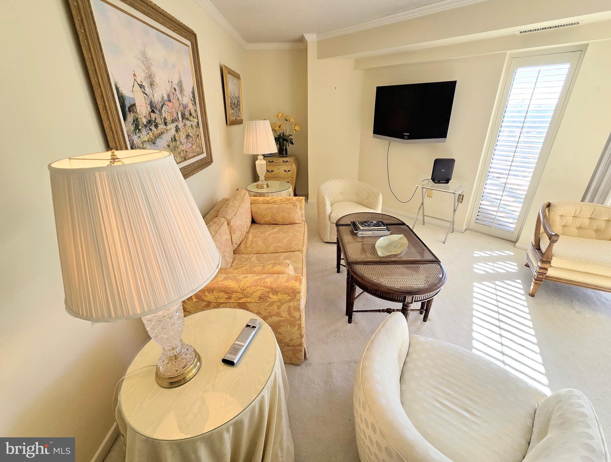 2111 Wisconsin Avenue Northwest, Unit 401 Washington, DC 20007 - Photo 5 of 16 a living room with furniture and a flat screen tv