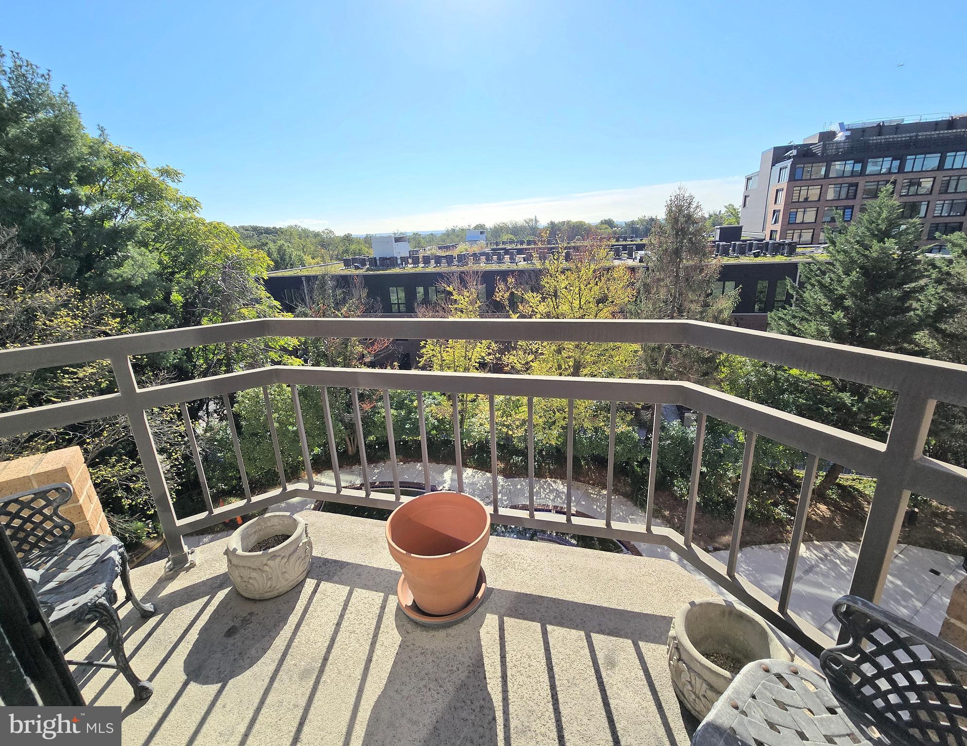 2111 Wisconsin Avenue Northwest, Unit 401 Washington, DC 20007 - Photo 7 of 16 a view of roof deck with two chairs and wooden floor