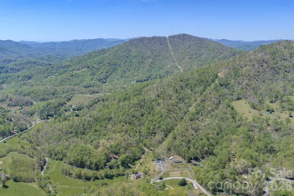 a view of a lush green hillside and a mountain view