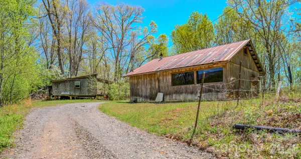 a view of a house with backyard and trees
