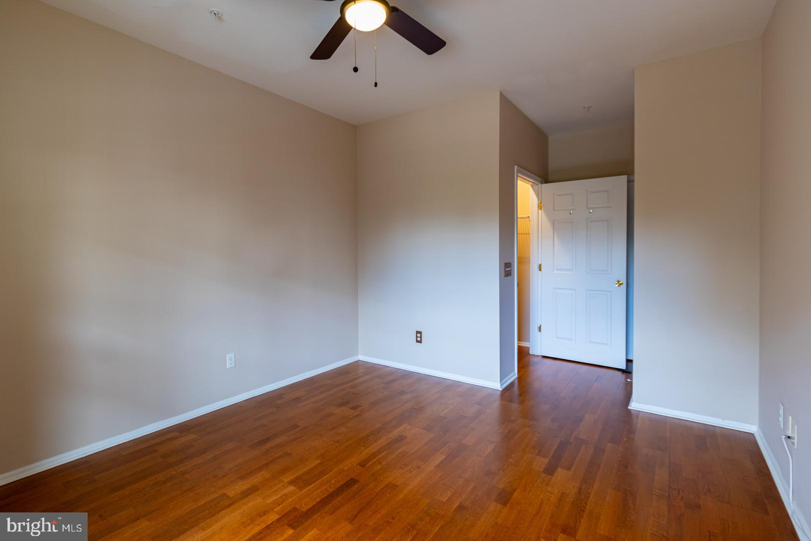 1600 Spring Gate Dr., Unit 2207 McLean, VA 22102 - Photo 20 of 32 an empty room with wooden floor and windows