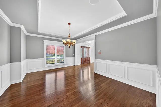 a view of a livingroom with wooden floor fireplace and windows