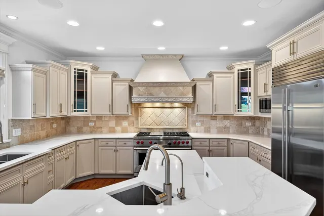 a large kitchen with kitchen island a sink a center island stainless steel appliances and a center island