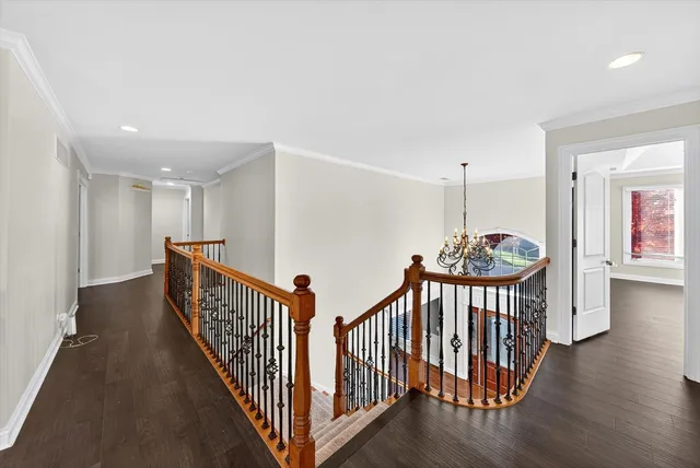a view of an entryway with wooden floor and a chandelier