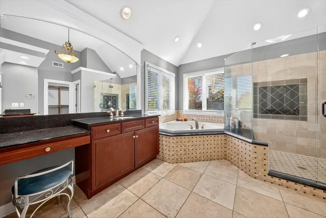 a large kitchen with stainless steel appliances granite countertop a refrigerator and a sink