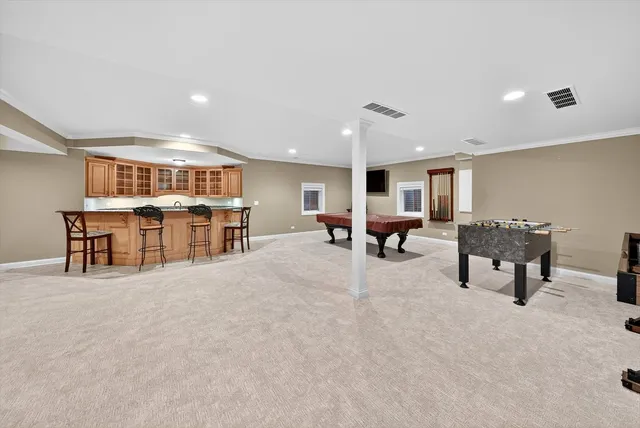 a kitchen with stainless steel appliances kitchen island granite countertop a table and chairs in it