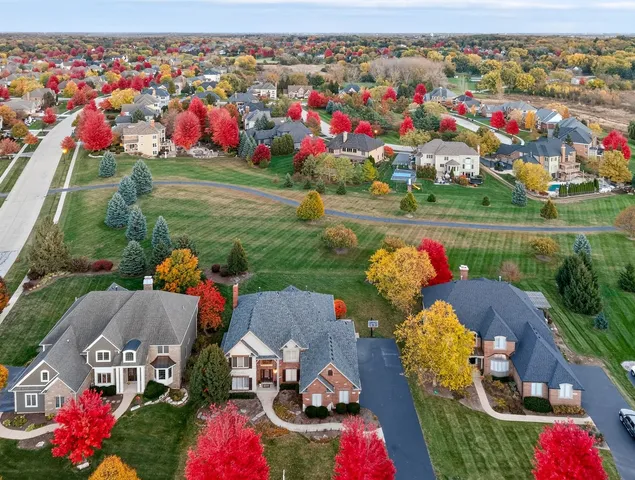 an aerial view of a house with swimming pool garden and patio