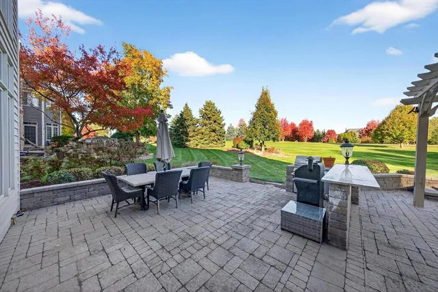 an aerial view of a house with swimming pool garden and patio
