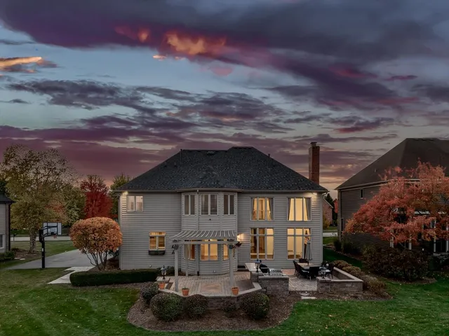 an aerial view of a house with a garden and lake view