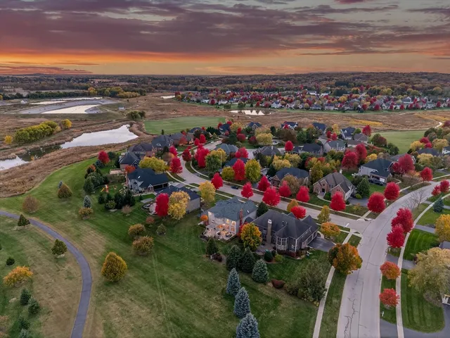 an aerial view of a house with a yard basket ball court and outdoor seating
