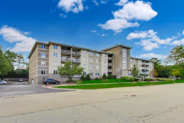 a front view of a building with tree s