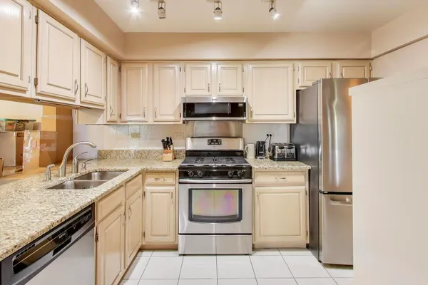 a kitchen with a stove a sink and a refrigerator
