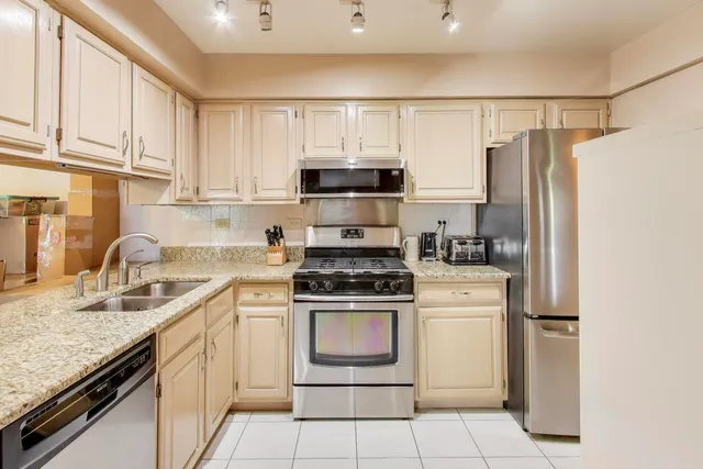 a kitchen with a stove a sink and a refrigerator
