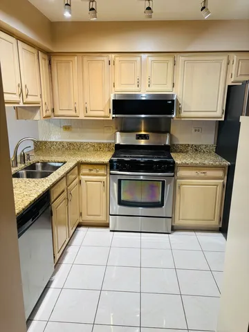 a kitchen with a stove top oven sink and cabinets