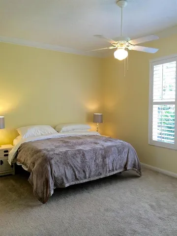 a spacious bedroom with a bed and a chandelier