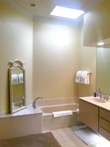 a living room with furniture a chandelier and a floor to ceiling window