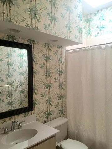 a spacious bedroom with a bed and a chandelier