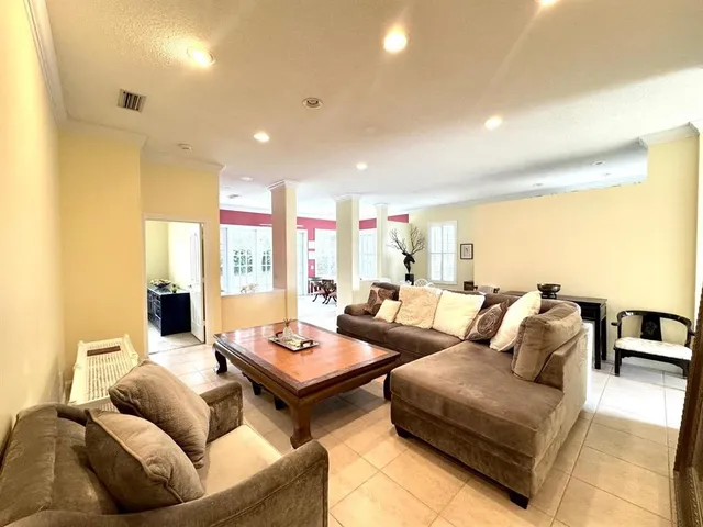a living room with furniture and large windows