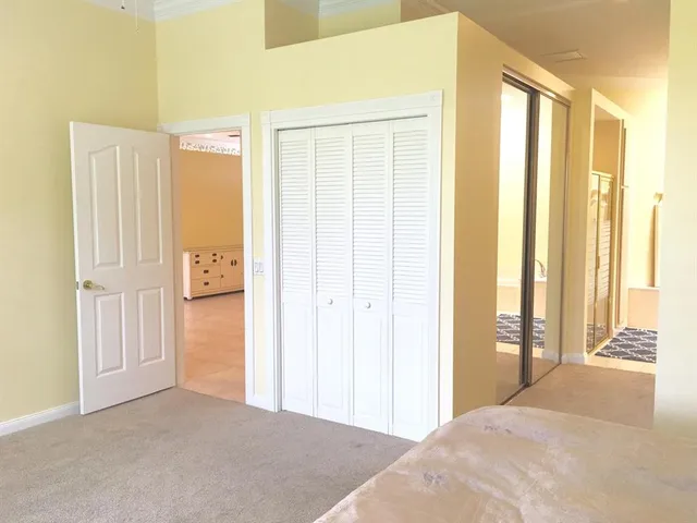 a view of a bedroom with wooden floor and windows