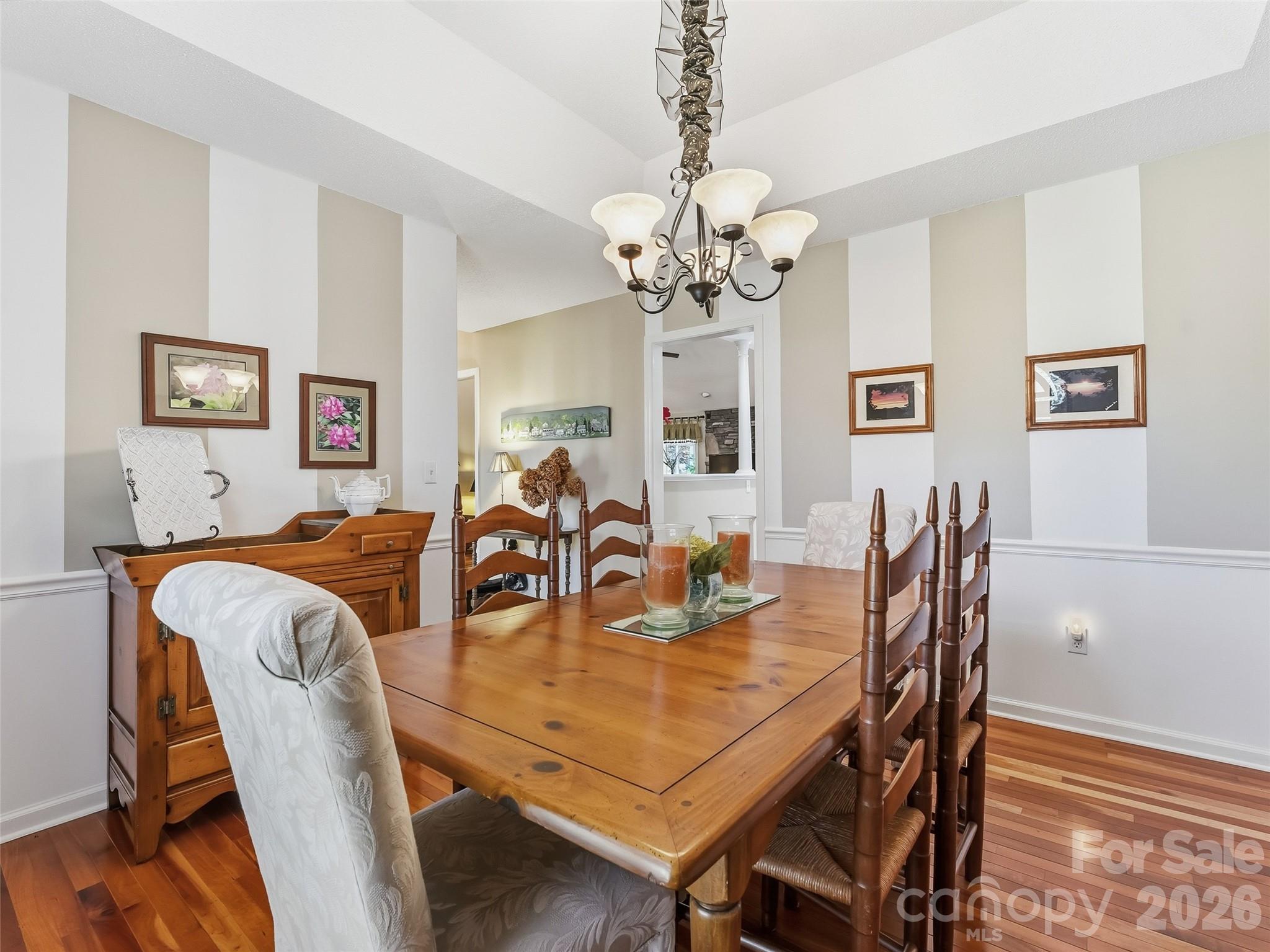 1340 Macedonia Road Saluda, NC 28773 - Photo 10 of 45 a view of a dining room with furniture a chandelier and wooden floor