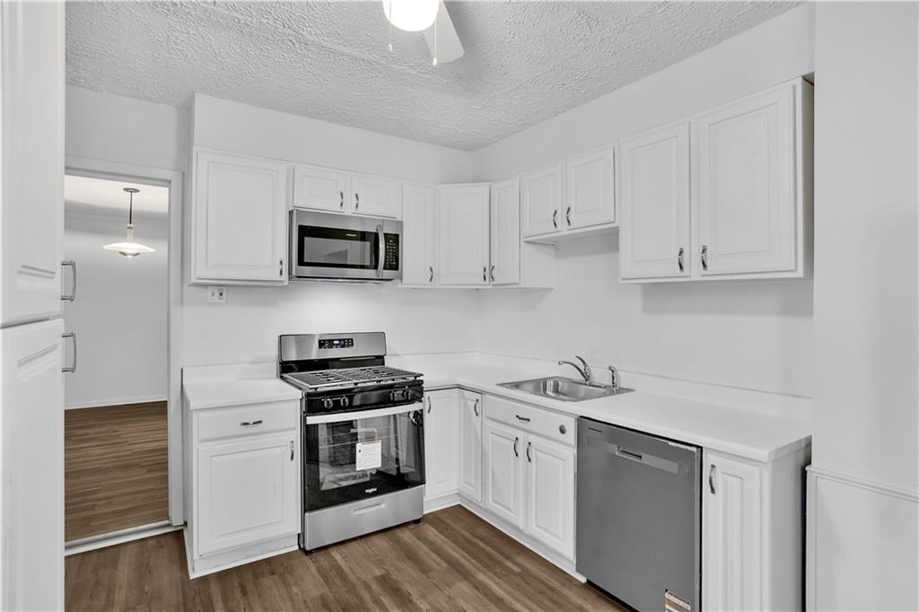 1841 Chislett Street Pittsburgh, PA 15206 - Photo 11 of 28 a kitchen with stainless steel appliances granite countertop a stove a sink and a microwave
