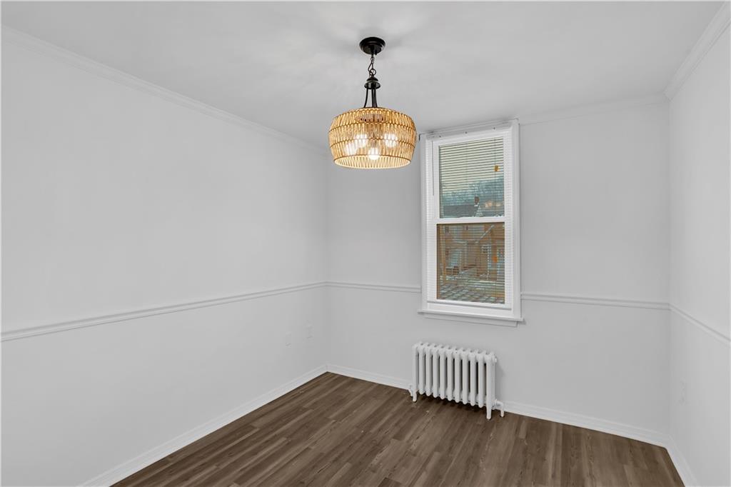 1841 Chislett Street Pittsburgh, PA 15206 - Photo 14 of 28 an empty room with wooden floor cabinet and windows