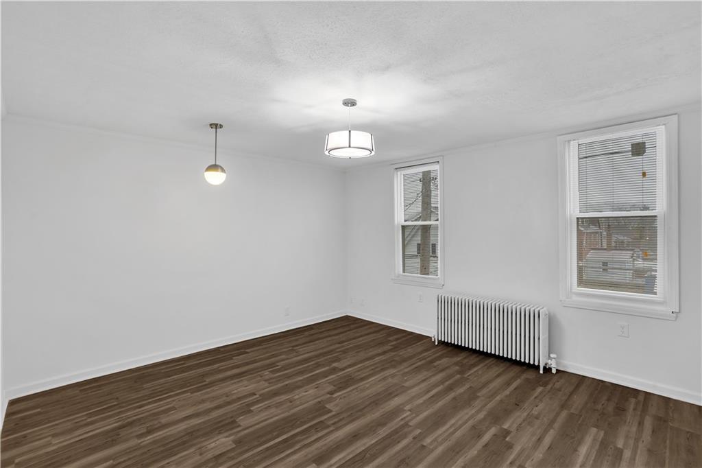 1841 Chislett Street Pittsburgh, PA 15206 - Photo 16 of 28 wooden floor in an empty room with a window