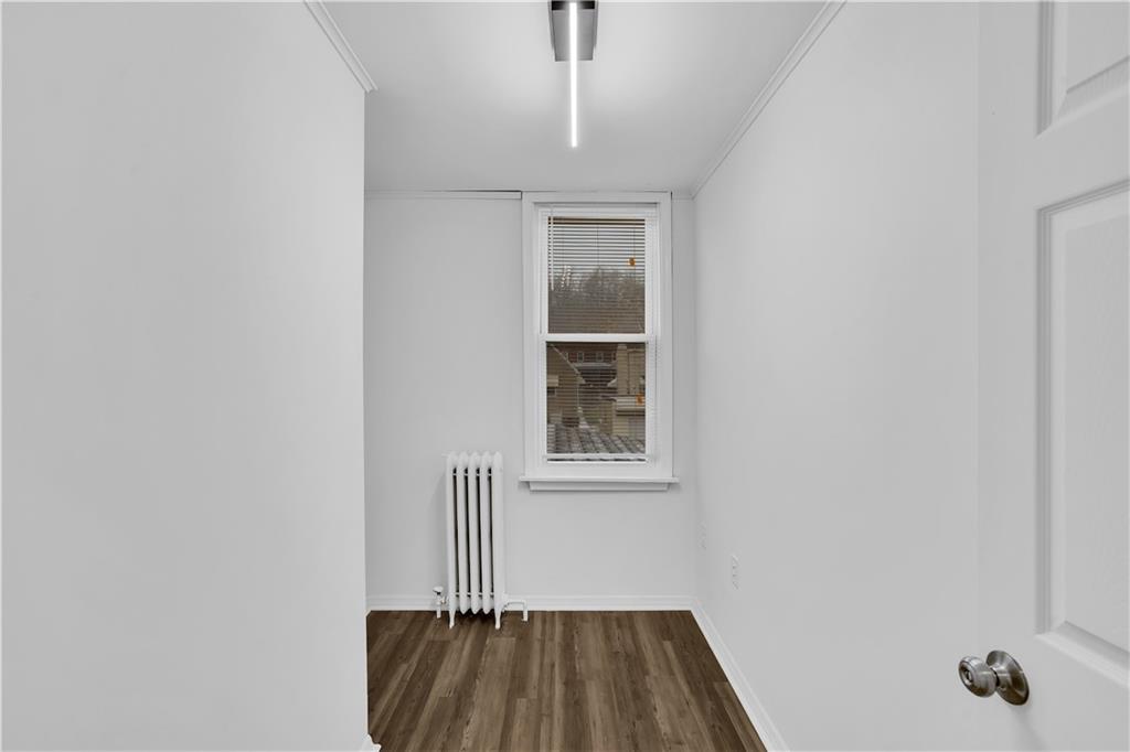 1841 Chislett Street Pittsburgh, PA 15206 - Photo 17 of 28 a view of a room with wooden floor and a window