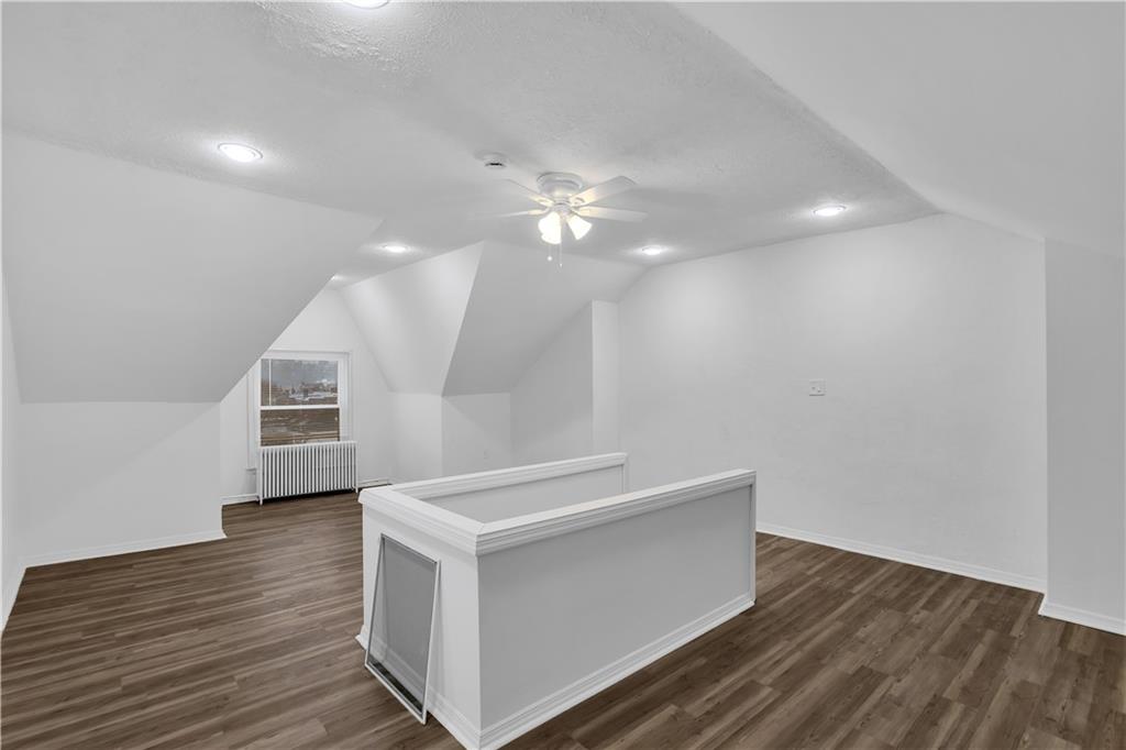1841 Chislett Street Pittsburgh, PA 15206 - Photo 20 of 28 a view of an empty room with wooden floor and a ceiling fan