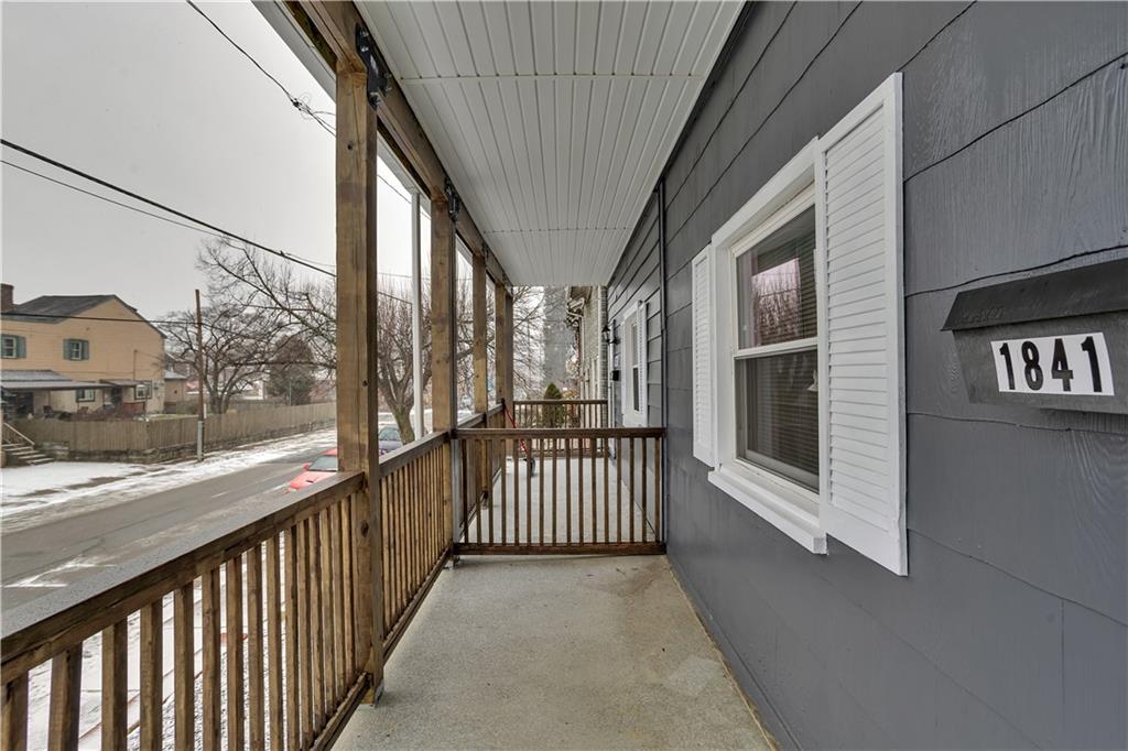 1841 Chislett Street Pittsburgh, PA 15206 - Photo 4 of 28 a view of a porch with wooden floor and iron fence