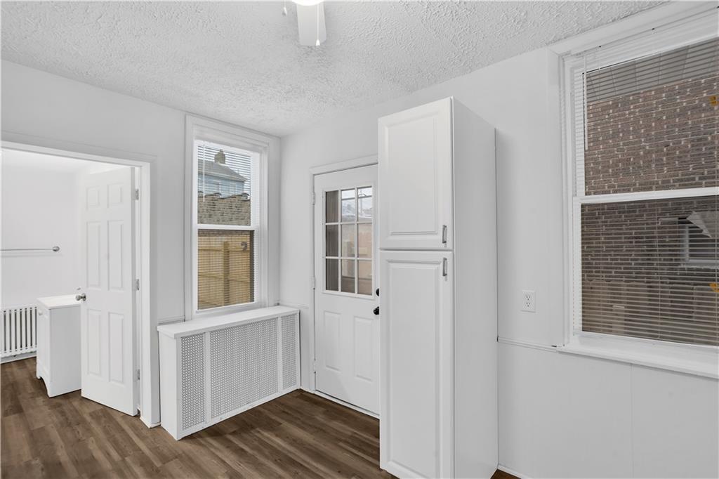 1841 Chislett Street Pittsburgh, PA 15206 - Photo 9 of 28 a view of an empty room with wooden floor and a window