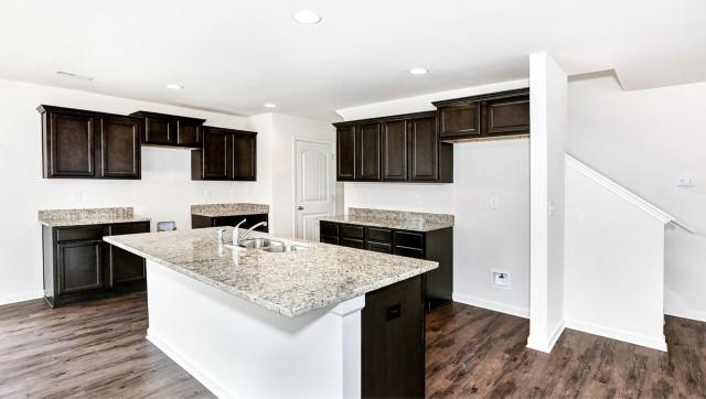 Picture not of Actual Home - Large kitchen with island and pantry.