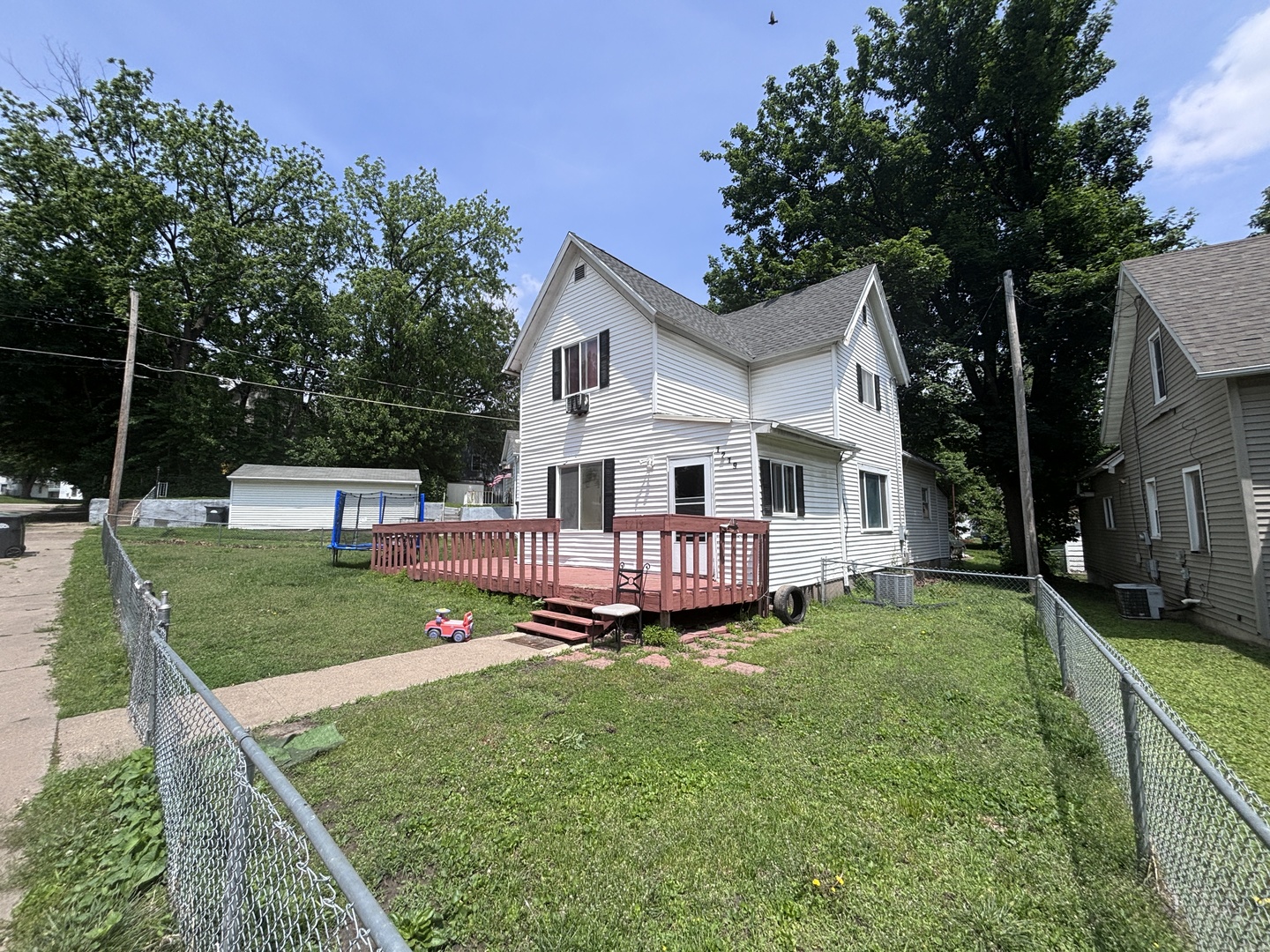 1219 South 7th Street Clinton, IA 52732 - Photo 2 of 15 a view of a house with a big yard and large trees