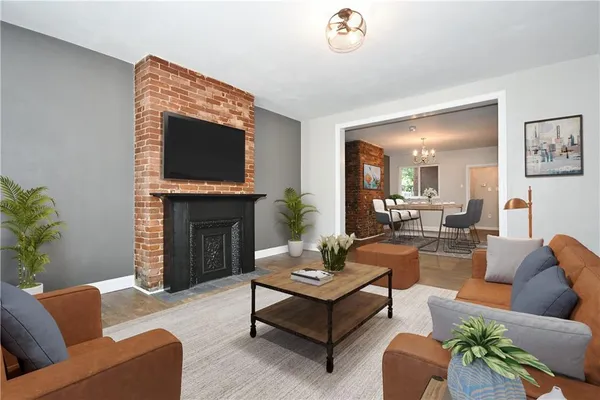 a living room with furniture a flat screen tv and a fireplace
