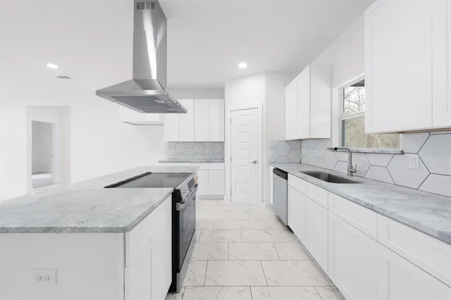 a kitchen with stainless steel appliances granite countertop a sink and a stove