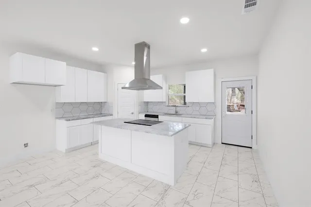 a kitchen with a sink stainless steel appliances and cabinets