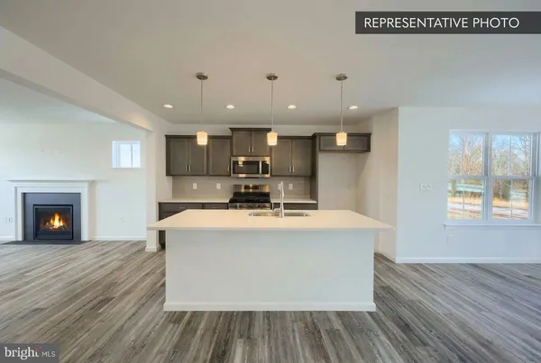 a view of kitchen with cabinets and wooden floor