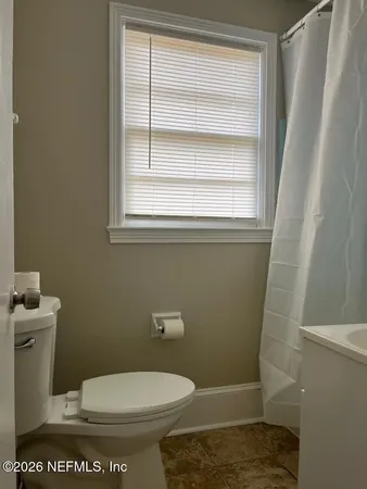 a bathroom with a toilet and a sink