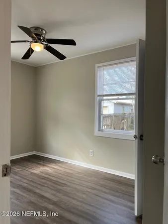 a view of a hallway with wooden floor