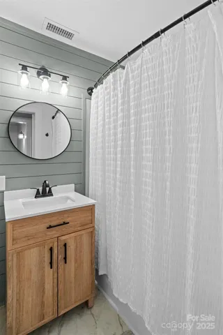 a view of a lush green forest with a lake and trees