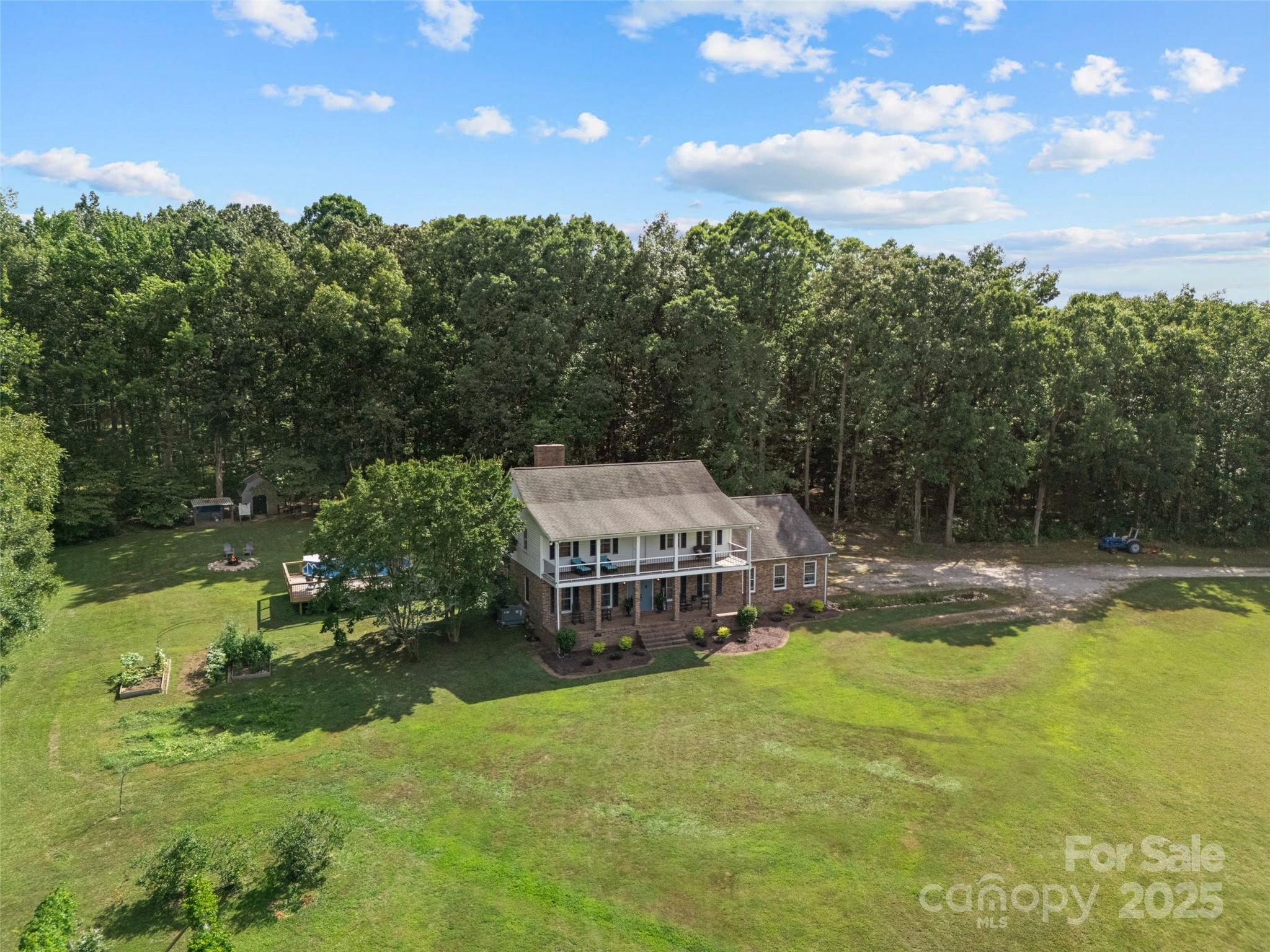 2520 Wooten Road Chester, SC 29706 - Photo 38 of 48 a view of a swimming pool with lawn chairs under an umbrella
