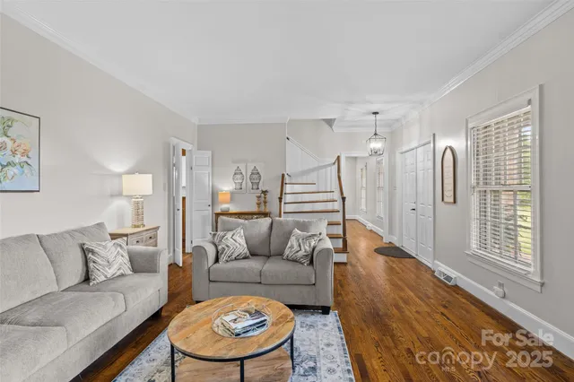 a living room with furniture a fireplace and a floor to ceiling window