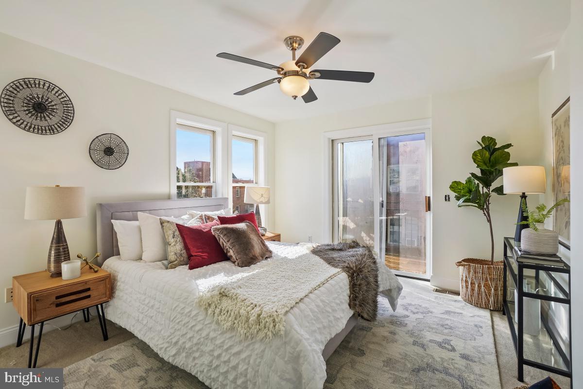 1832 Swann Street Northwest, Unit D Washington, DC 20009 - Photo 13 of 29 a bedroom with a bed and a chandelier