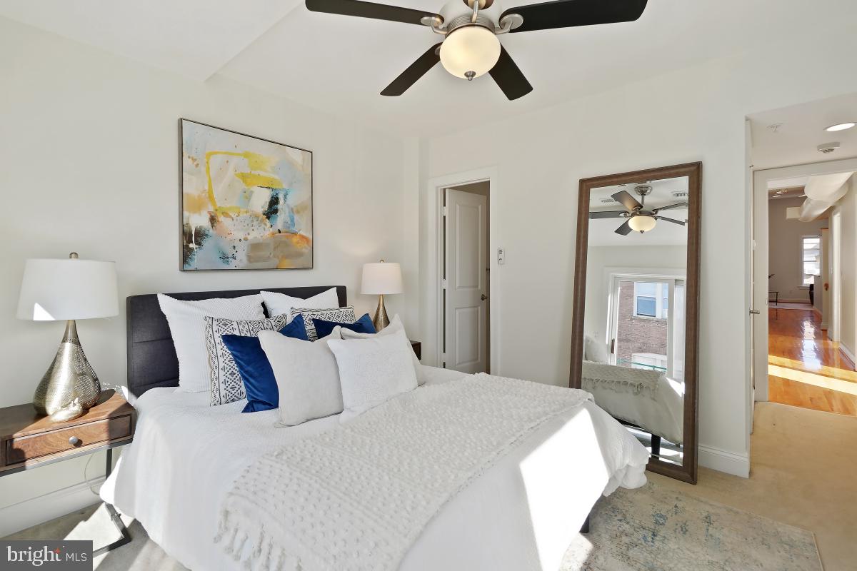 1832 Swann Street Northwest, Unit D Washington, DC 20009 - Photo 21 of 29 a bedroom with bed and wall painting