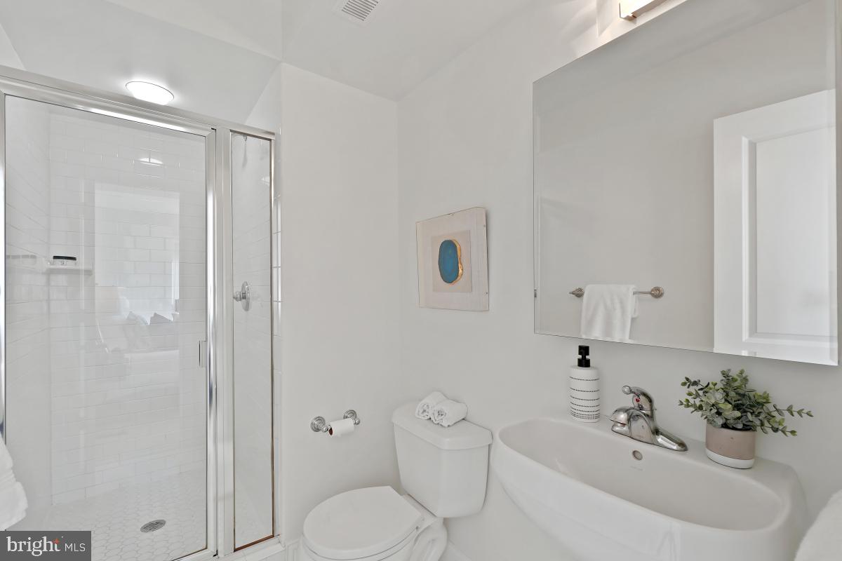 1832 Swann Street Northwest, Unit D Washington, DC 20009 - Photo 22 of 29 a bathroom with a sink toilet and shower