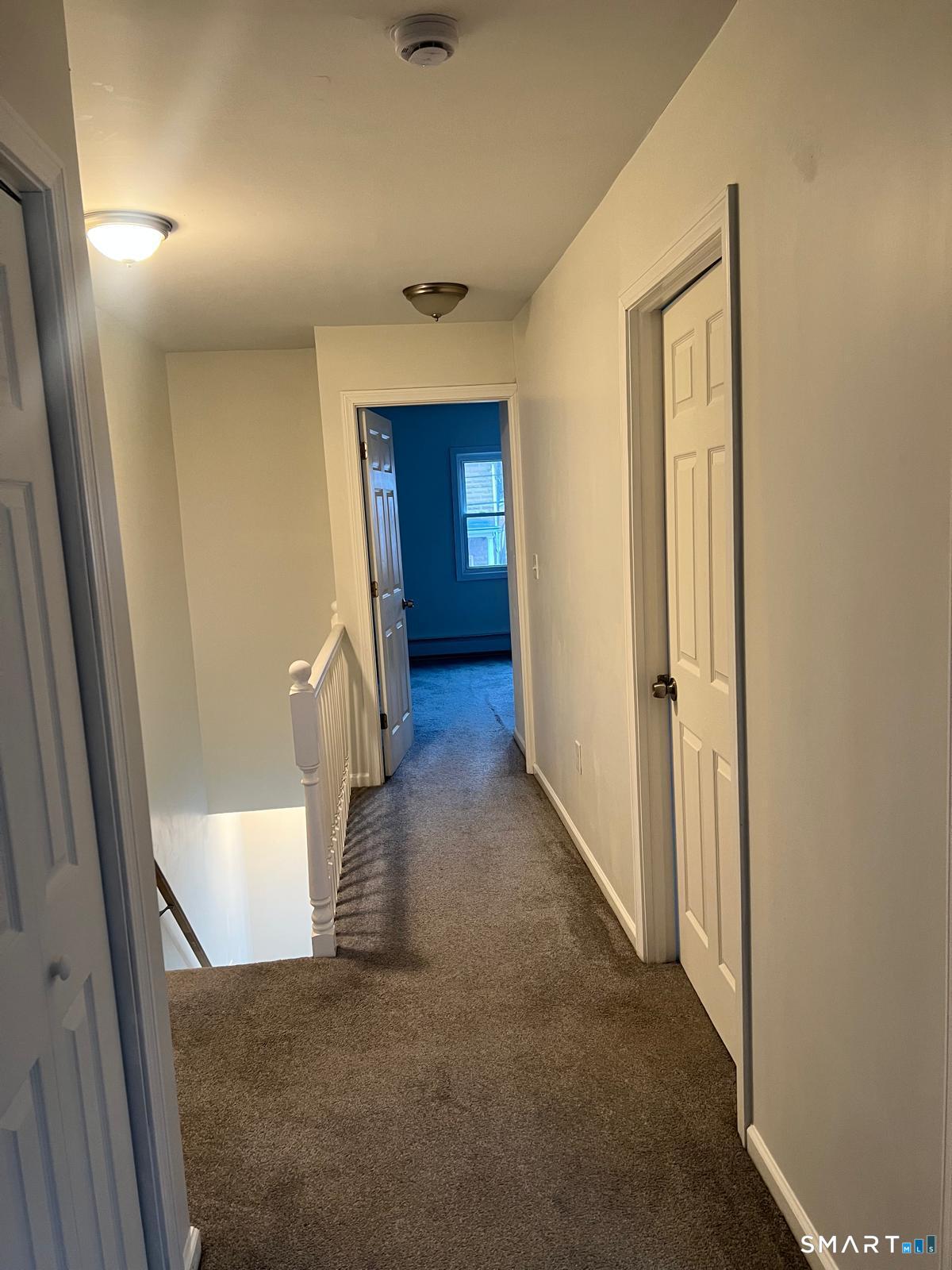 34 Norman Street Manchester, CT 06040 - Photo 11 of 19 a view of a hallway with wooden floor and staircase